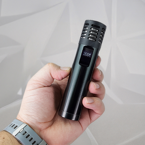 Hand holding a Arizer Air Max vaporizer.