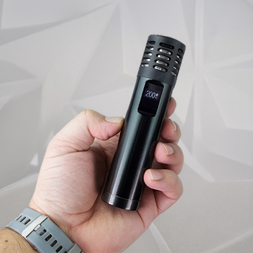 Hand holding a Arizer Air Max vaporizer.