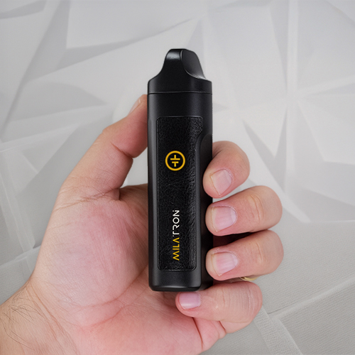 Hand holding a Tronian Milatron vaporizer