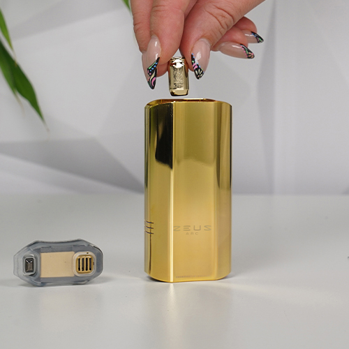 Inserting a gold concentrate pod into a gold Zeus Arc GT4 vaporizer, with the removable mouthpiece.
