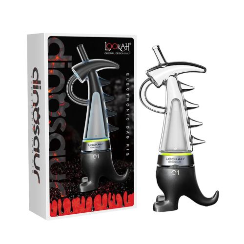 Lookah Dinosaur electronic dab rig displayed next to its packaging, featuring a distinctive dinosaur-inspired design with a purple base resembling dinosaur feet, clear glass body, spiked detailing, and a curved mouthpiece.