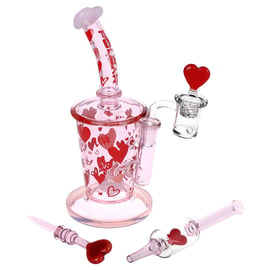 Pulsar Valentine’s Love Hearts Dab Rig Set in pink glass with red heart graphics, curved mouthpiece, quartz banger, dab tool, and matching dab straw.