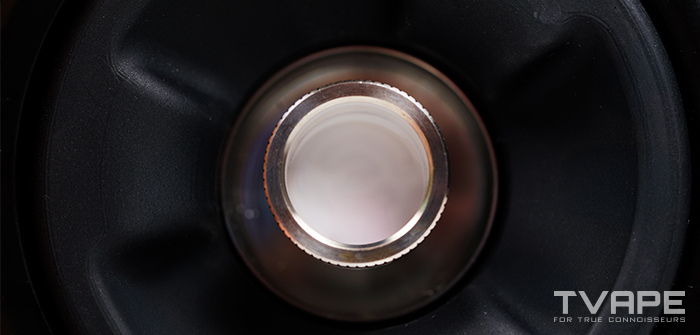 Top-down close-up of the BurstHit All Wall Heating Chamber inside the Tronian Omegatron 2 base, showing its knurled stainless steel rim and the bucket inside.
