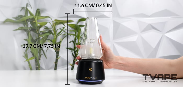 Hand holding the Tronian Omegatron 2 vapor cup, with dimension markings showing 19.7 cm (7.75 in) height and 11.6 cm width.