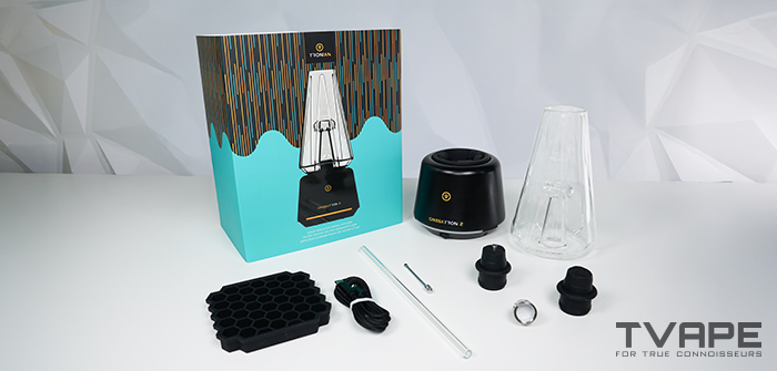 Tronian Omegatron 2 unboxed beside its retail box: black base, glass cup, honeycomb silicone ice tray, USB-C cable, glass straw, packing tool, wax heating chamber cover, 510 cover and BurstHit All Wall Heating Chamber.