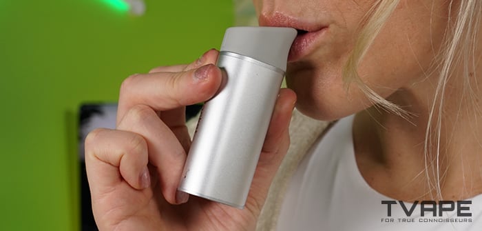 A woman is inhaling from the Yocan Black Pocket dab pen