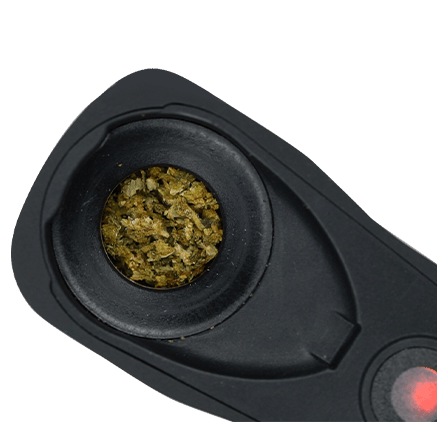 Vaporizer heating chamber filled with ground dry material